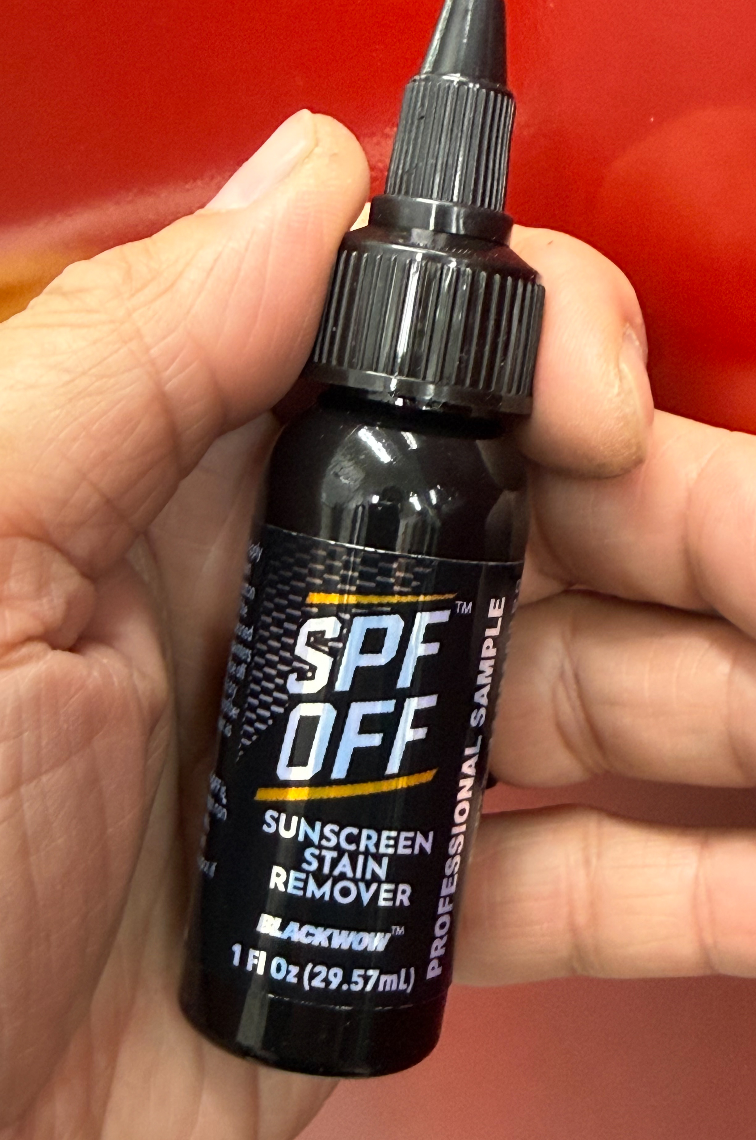 Hand holding SPF OFF 1 oz sample