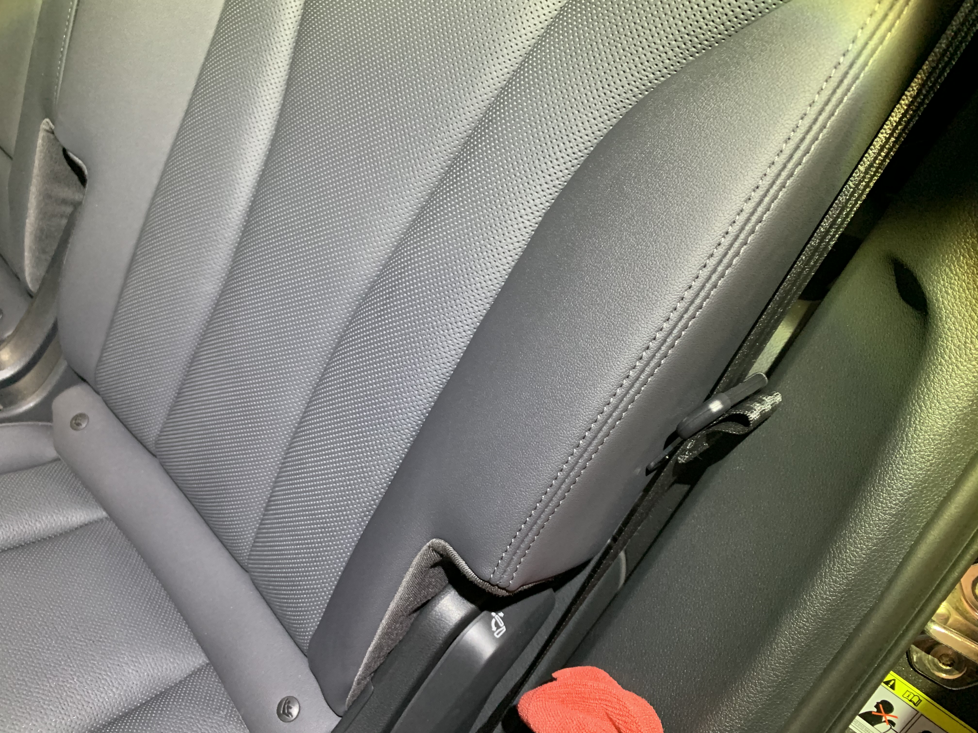 Light grey leather seat after PreWow — stain completely removed