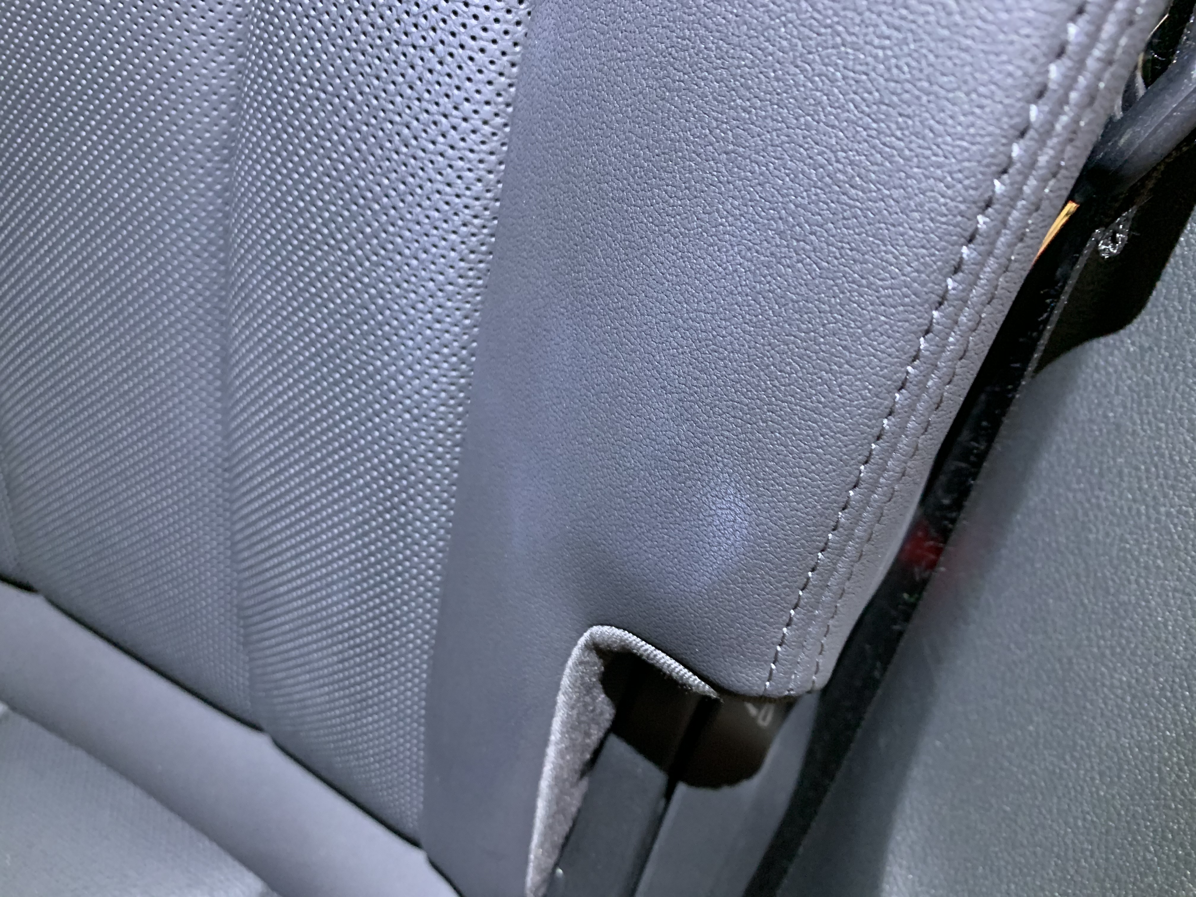 Sunscreen stain on light grey leather seat — before PreWow